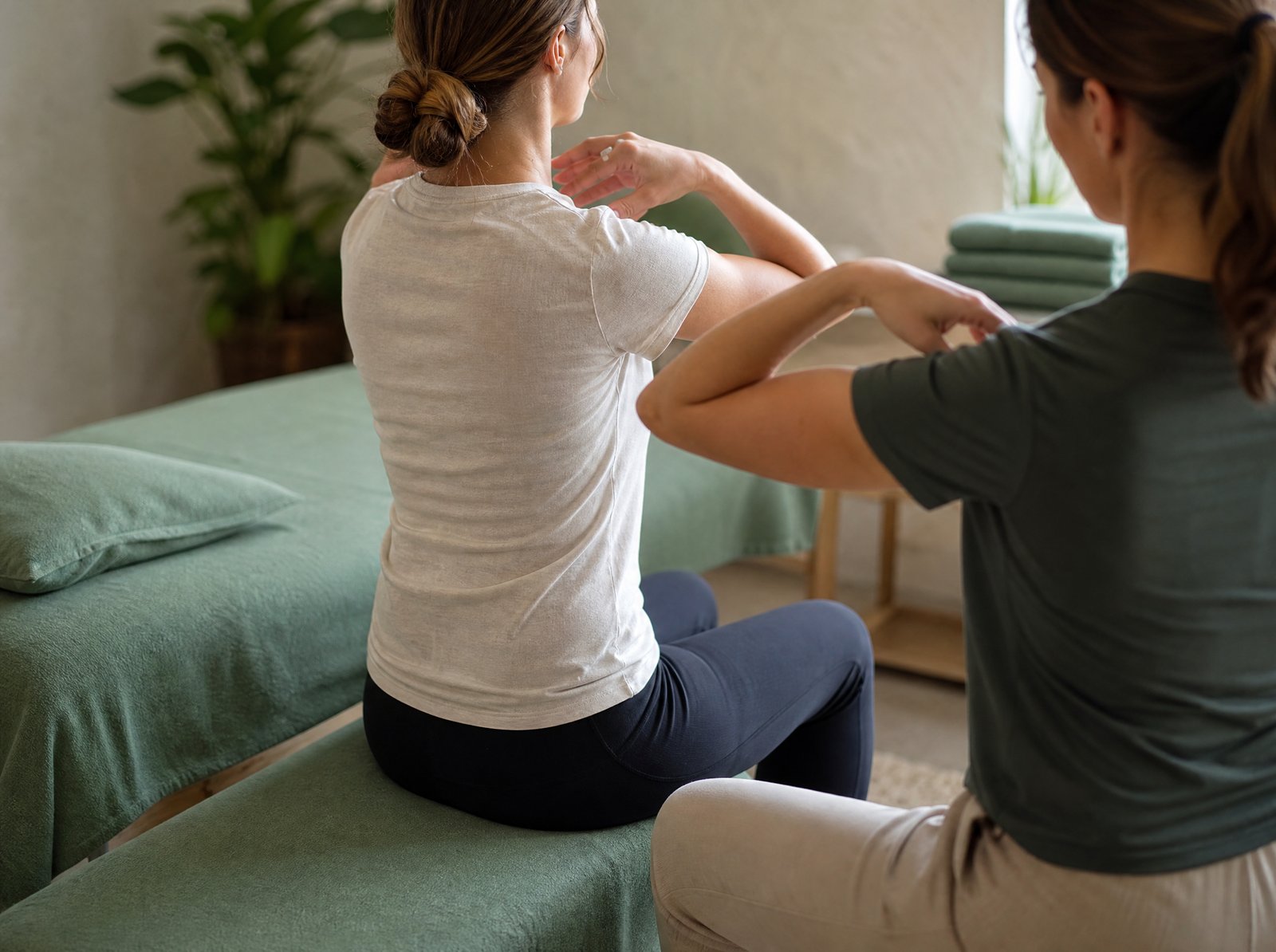 Physiotherapist explaining a home exercise to a patient during their first session