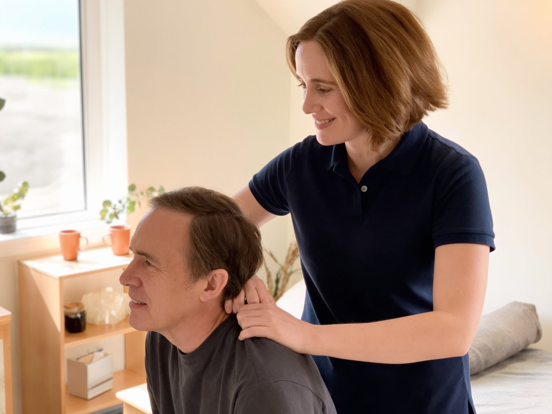 Fiona Casey assessing a patient's shoulder during a physiotherapy consultation in her Ennis clinic